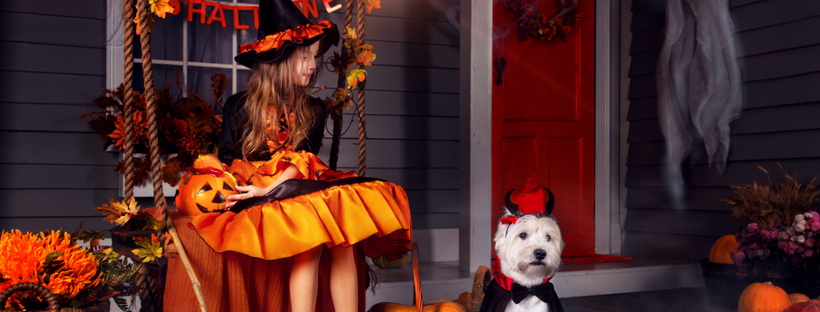 Girl and her dog wearing halloween costume