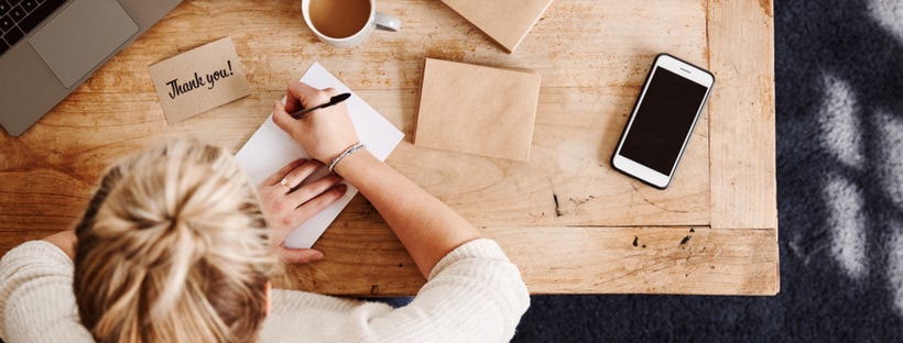 Woman writing on a notepad