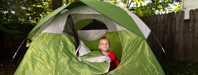 Little boy inside a tent