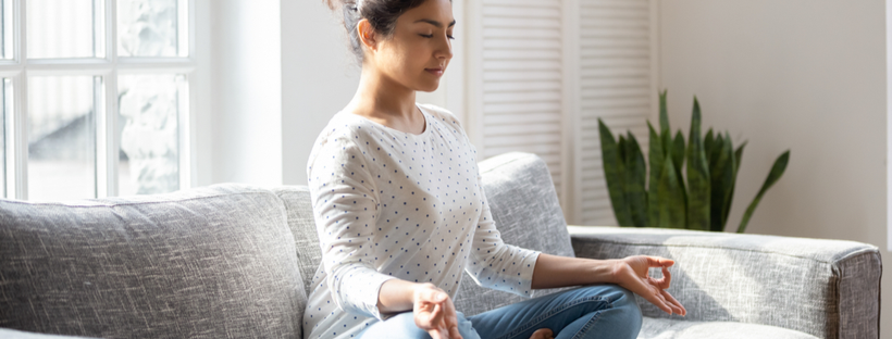 Girl meditating on sofa