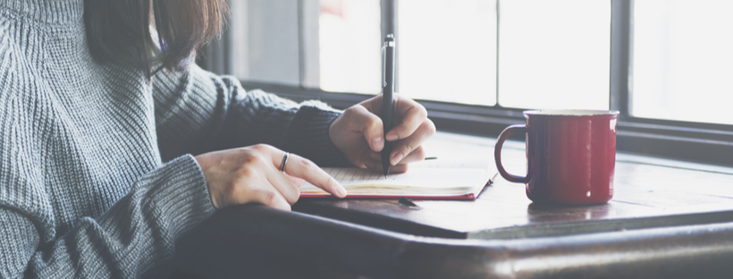 Woman writing in notebook