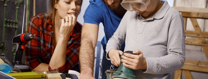 Father teaching son the use of tools