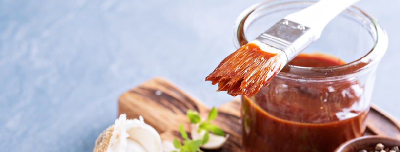 Sauce basting brush on top of a glass jar