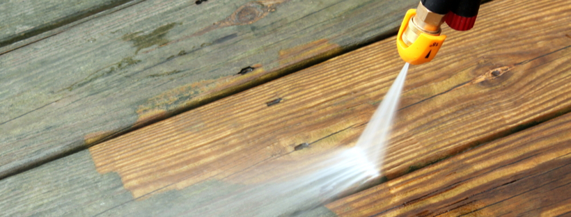 Water jet cleaning dirty wooden floor boards
